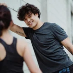 Man and woman stretching outdoors during a casual workout, illustrating being active in a way that fits your lifestyle.